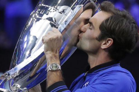 Team Europe's Roger Federer kisses the Laver Cup after defeating Team World, Sunday, Sept. 23, 2018, in Chicago. (AP Photo/Jim Young)