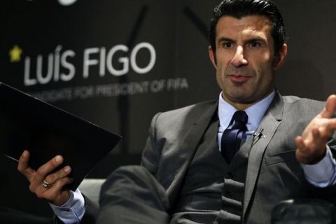 Luis Figo speaks to the media as he launches his FIFA Presidential Campaign Manifesto, at Wembley Stadium, London, Thursday, Feb. 19, 2015.  The 2001 FIFA world player of the year launched his manifesto on Thursday at Wembley and spoke about his plan to restore the credibility and rebuild trust in football¿s world governing body, as he tries to unseat Sepp Blatter, who is seeking a fifth, four-year term as president. FIFA vice president Prince Ali bin al-Hussein and Dutch football association chairman Michael van Praag. (AP Photo/Matt Dunham) Britain Soccer FIFA Figo