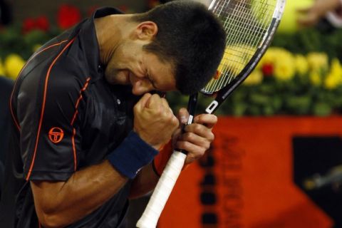 Novak Djokovic of Serbia celebrates his victory over David Ferrer of Spain after their Madrid Open tennis match in Madrid May 6, 2011.  REUTERS/Sergio Perez  (SPAIN - Tags: SPORT TENNIS)