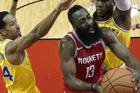 Houston Rockets' James Harden (13) goes up for a shot as Golden State Warriors' Shaun Livingston (34) and Kevon Looney defend during the first half of an NBA basketball game Thursday, Nov. 15, 2018, in Houston. (AP Photo/David J. Phillip)