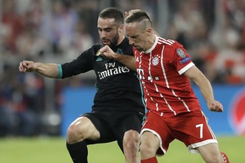 Real Madrid's Daniel Carvajal, left, and Bayern's Franck Ribery challenge for the ball during the semifinal first leg soccer match between FC Bayern Munich and Real Madrid at the Allianz Arena stadium in Munich, Germany, Wednesday, April 25, 2018. (AP Photo/Matthias Schrader)