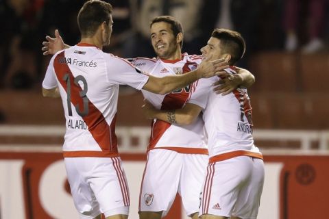 Camilo Mayada of Argentina's River Plate, center, celebrates with teammates after scoring against Peru's Melgar at a Copa Libertadores soccer match in Arequipa, Peru, Thursday, May 18, 2017. (AP Photo/Martin Mejia)