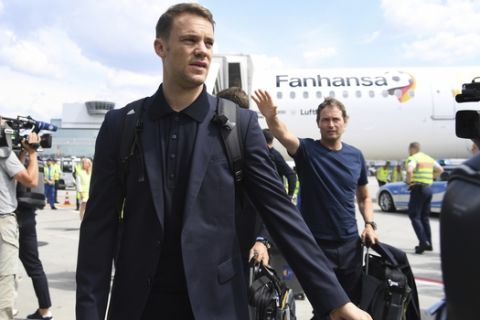 Goalkeeper Manuel Neuer leaves a plane in Frankfurt, Germany, Thursday, June 28, 2018, one day after the German team was eliminated from the soccer World Cup in Russia. (Ina Fassbender/dpa via AP)
