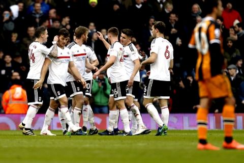 Fulham's Chris Martin, second left, celebrates scoring his side's second goal of the game with his teammates during the English FA Cup, Fourth Round match, Fulham vs Hull City at Craven Cottage, London, Sunday Jan. 29, 2017. (Paul Harding/PA via AP)
