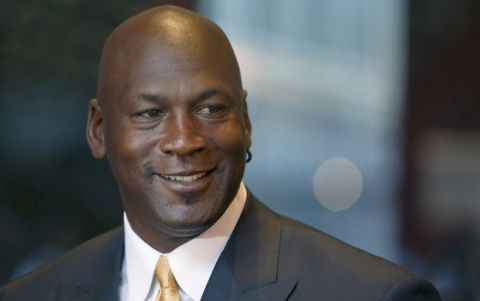 FILE - In this Aug. 21, 2015, file photo, former NBA star Michael Jordan smiles at reporters in Chicago. Nike is opening a Michael Jordan-only store in Chicago's Loop on Saturday, Oct. 24, 2015. The new Jordan Brand store will sell merchandise with the trademarked Michael Jordan "Jumpman" silhouette. Nike also plans stores in New York, Los Angeles and Toronto featuring the former Chicago Bulls star. (AP Photo/Charles Rex Arbogast, File)