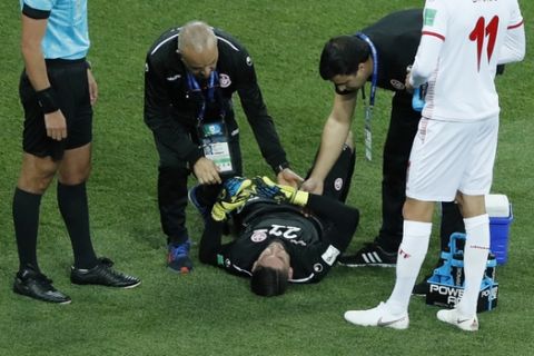 Tunisia goalkeeper Mouez Hassen is injured during the group G match between Tunisia and England at the 2018 soccer World Cup in the Volgograd Arena in Volgograd, Russia, Monday, June 18, 2018. (AP Photo/Rebecca Blackwell)
