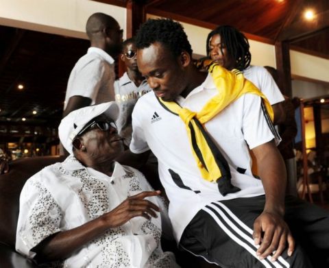 Michael Essien speaks to his father before the press conference   