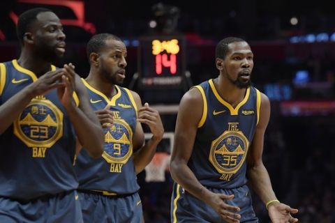 Golden State Warriors forward Kevin Durant, right, reacts as he fouls out of the game while forward Draymond Green, left, and guard Andre Iguodala look on during the overtime portion of an NBA basketball game against the Los Angeles Clippers Monday, Nov. 12, 2018, in Los Angeles. The Clippers won 121-116 in overtime. (AP Photo/Mark J. Terrill)