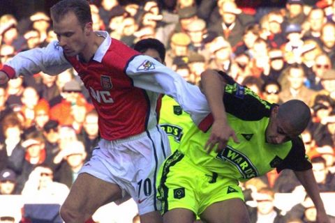 Denis Bergkamp, left, of Arsenal challenges Curtis Woodhouse of Sheffield United for the ball during the fifth round of the FA Cup at Arsenal's Highbury ground, in London Saturday, February 13, 1999. (AP Photo/Louisa Buller)