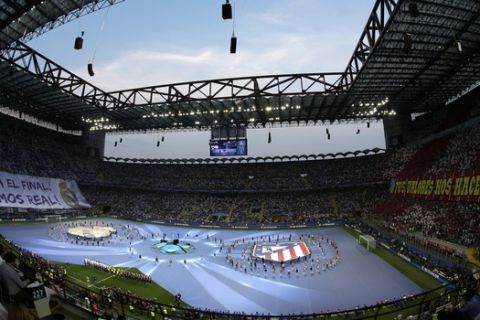 Real Madrid and Atletico Madrid teams stand during the opening ceremony ahead of the Champions League final soccer match between Real Madrid and Atletico Madrid at the San Siro stadium in Milan, Italy, Saturday, May 28, 2016.  (AP Photo/Alessandra Tarantino)