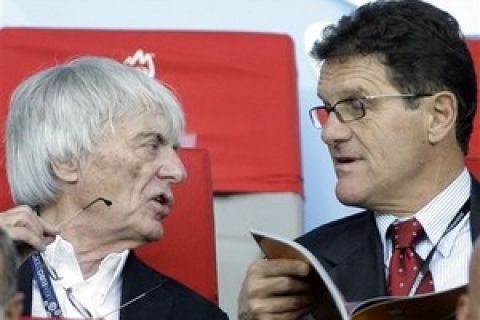 Formula One boss Bernie Ecclestone, left, talks to Fabio Capello, manager of the English national soccer team prior to the quarterfinal match between Croatia and Turkey in Vienna, Austria, Friday, June 20, 2008, at the Euro 2008 European Soccer Championships in Austria and Switzerland. (AP Photo/Frank Augstein)