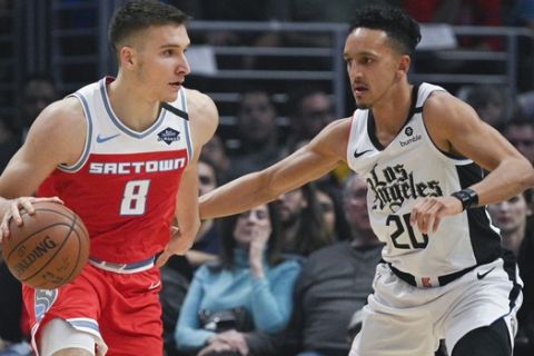 Sacramento Kings guard Bogdan Bogdanovic, left, handles the ball while Los Angeles Clippers guard Landry Shamet defends during the first half of an NBA basketball game in Los Angeles, Thursday, Jan. 30, 2020. (AP Photo/Kelvin Kuo)