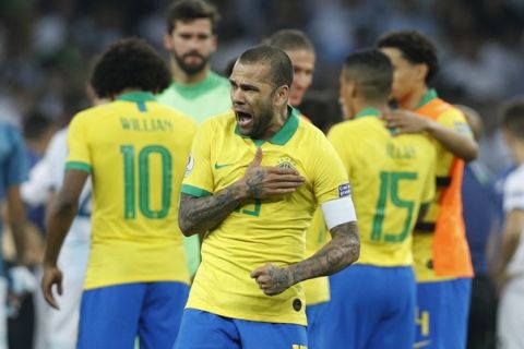 Brazil's Dani Alves celebrates his team's 2-0 victory over Argentina at the end of their Copa America semifinal soccer match at Mineirao stadium in Belo Horizonte, Brazil, Tuesday, July 2, 2019. (AP Photo/Victor R. Caivano)