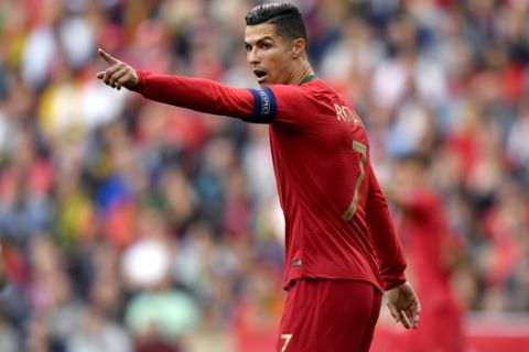 Portugal's Cristiano Ronaldo points during the UEFA Nations League semifinal soccer match between Portugal and Switzerland at the Dragao stadium in Porto, Portugal, Wednesday, June 5, 2019. (AP Photo/Martin Meissner)