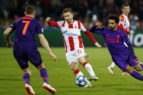 Red Star's Marko Marin, center, vies the ball past Liverpool midfielder James Milner, left, and Liverpool forward Mohamed Salah, right, during the Champions League group C soccer match between Red Star and Liverpool at the Rajko Mitic stadium in Belgrade, Serbia, Tuesday, Nov. 6, 2018. (AP Photo/Marko Drobnjakovic)