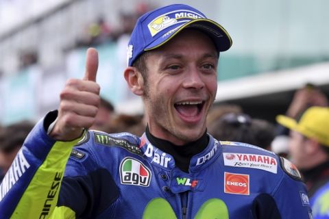 Italy's MotoGP rider Valentino Rossi celebrates after his second place finish at the Australian Motorcycle Grand Prix at Phillip Island near Melbourne, Australia, Sunday, Oct. 22, 2017. (AP Photo/Andy Brownbill)