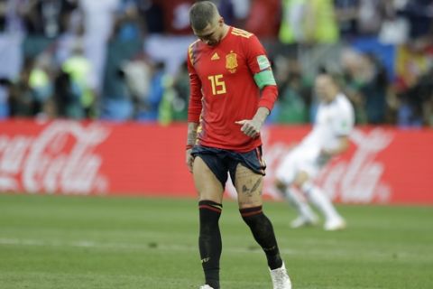Spain's Sergio Ramos walks over the pitch during the penalty shootout before his team was eliminated during the round of 16 match between Spain and Russia at the 2018 soccer World Cup at the Luzhniki Stadium in Moscow, Russia, Sunday, July 1, 2018. (AP Photo/Matthias Schrader)