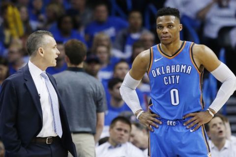 Oklahoma City Thunder head coach Billy Donovan left, talks with guard Russell Westbrook (0) during Game 5 of an NBA basketball first-round playoff series against the Utah Jazz in Oklahoma City, Wednesday, April 25, 2018. (AP Photo/Sue Ogrocki)