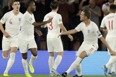 England's Raheem Sterling, second from left, celebrates with teammates after scoring his side's first goal during the Euro 2020 group A qualifying soccer match between England and Kosovo at St Mary's Stadium in Southampton, England, Tuesday, Sept. 10, 2019 . (AP Photo/Matt Dunham)