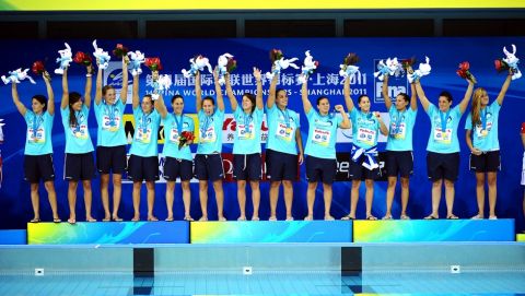 Greece's players celebrate on the podium after winning gold for the women's final water polo match of the FINA World Championships at the Oriental Sports Center in Shanghai on July 29, 2011. Greece defeated China 9-8.  AFP PHOTO/PHILIPPE LOPEZ