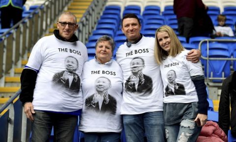 Leicester City fans wear shirts bearing a picture of Vichai Srivaddhanaprabha that read 'The Boss' before kick-off of the English Premier League soccer match between Cardiff City and Leicester City at the Cardiff City Stadium, Cardiff. Wales. Saturday Nov. 3, 2018. (Simon Galloway/PA via AP)