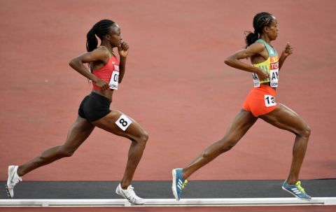 Ethiopia's Almaz Ayana leads Kenya's Hellen Onsando Obiri during the Women's 5000 meters final at the World Athletics Championships in London Sunday, Aug. 13, 2017. (AP Photo/Martin Meissner)