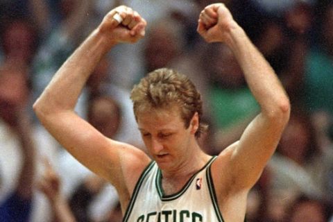 Larry Bird of the Boston Celtics raises his arms in victory at the end of Boston's 108-107 win over the Detroit Pistons in the fifth game of their NBA playoff series at the Boston Garden, Ma., Tuesday night, May 26, 1987.  (AP Photo/Peter Southwick)