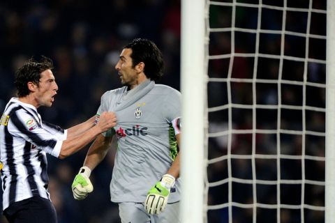 Juventus goalkeeper Gianluigi Buffon (R) is congratulated by midfielder Claudio Marchiso after saving a penalty kick against AS Roma Francesco Totti  during their Italian Serie A football match in Rome's Olympic Stadium on December 12, 2011. AFP PHOTO / Filippo MONTEFORTE (Photo credit should read FILIPPO MONTEFORTE/AFP/Getty Images)