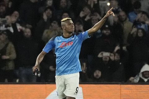 Napoli's Victor Osimhen celebrates after scoring the opening goal during the Champions League round of 16 second leg soccer match between SSC Napoli and Eintracht Frankfurt at the Diego Armando Maradona stadium in Naples, Italy, Wednesday, March 15, 2023. (AP Photo/Gregorio Borgia)