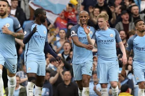 Manchester City's Kevin De Bruyne, center right, celebrates scoring against West Bromwich Albion during the English Premier League soccer match against Manchester City at the Etihad Stadium, Manchester, England, Tuesday May 16, 2017. (Martin Rickett/PA via AP)