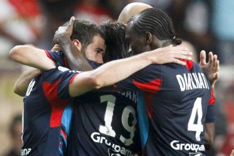 Olympique Lyon's Pape Diakhate (R) celebrates with his teammates after scoring against AS Monaco during their French Ligue 1 soccer match at the Louis II stadium in Monaco, May 29, 2011.    REUTERS/Robert Pratta (MONACO - Tags: SPORT SOCCER)
