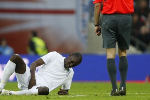 England's Carlton Cole reacts to an injury as he plays against Slovakia during their international friendly soccer match at Wembley Stadium in London, Saturday, March 28, 2009.  (AP Photo/Sang Tan)