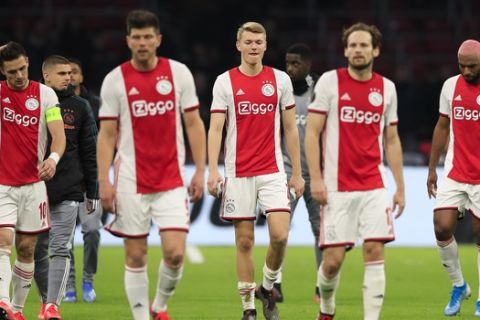 Ajax players react to the team's elimination after a round of 32, second leg, Europa League soccer match between Ajax and Getafe at the Johan Cruyff ArenA in Amsterdam, Netherlands, Thursday, Feb. 27, 2020. (AP Photo/Peter Dejong )