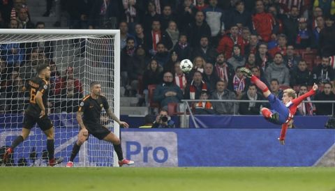 Atletico's Antoine Griezmann shoots to score his side's opening goal during a Champions League group C soccer match between Atletico Madrid and Roma at the Wanda Metropolitano stadium in Madrid, Wednesday, Nov. 22, 2017. (AP Photo/Paul White)