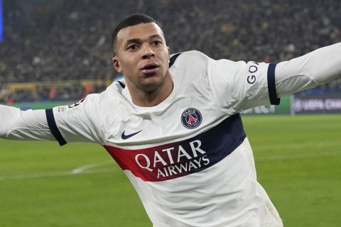 PSG's Kylian Mbappe celebrates after scoring a goal that was later disallowed during the Champions League Group F soccer match between Borussia Dortmund and Paris Saint-Germain at the Signal Iduna Park in Dortmund, Germany, Wednesday, Dec. 13, 2023. (AP Photo/Martin Meissner)