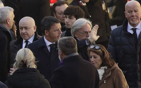 Former premier and Democratic Party president Matteo Renzi, center, arrives with Fiorentina owner Diego Della Valle, for the funeral ceremony of Italian player Davide Astori in Florence, Italy, Thursday, March 8, 2018. The 31-year-old Astori was found dead in his hotel room on Sunday after a suspected cardiac arrest before his team was set to play an Italian league match at Udinese. (AP Photo/Alessandra Tarantino)