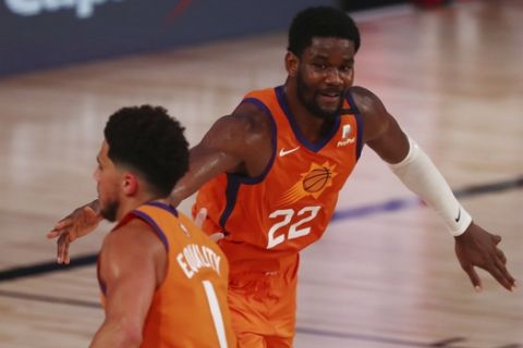 Phoenix Suns center Deandre Ayton (22) is congratulated by guard Devin Booker (1) after making a three-point basket against the Washington Wizards in the second half of an NBA basketball game in Lake Buena Vista, Fla., Friday, July 31, 2020. (Kim Klement/Pool Photo via AP)