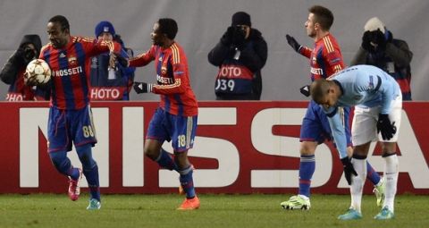 CSKA Moscow's Ivorian forward Seydou Doumbia (L) celebrates with teammates after scoring a goal during the UEFA Champions League group E football match between CSKA Moscow and Manchester City at the Khimki Arena in Moscow on October 21, 2014.  AFP PHOTO / YURI KADOBNOV        (Photo credit should read YURI KADOBNOV/AFP/Getty Images)