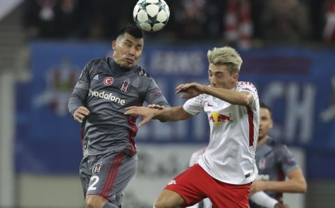 Besiktas' Gary Medel, left, and Leipzig's Kevin Kampl go for a header during the Champions League Group G soccer match between RB Leipzig and Besiktas JK in Leipzig, Germany, Wednesday, Dec. 6, 2017. (AP Photo/Michael Sohn)