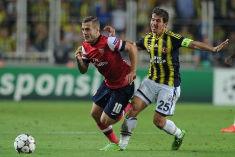 ISTANBUL, TURKEY - AUGUST 21: Jack Wilshere of Arsenal breaks past Emre Belozoglu of Fenerbache during the UEFA Champions League Play Off first leg match between Fenerbache SK and Arsenal FC at sukru Saracoglu Stadium on August 21, 2013 in Istanbul, Turkey. (Photo by Stuart MacFarlane/Arsenal FC via Getty Images)