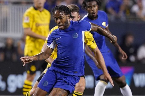 Chelsea forward Raheem Sterling, front, controls the ball past Borussia Dortmund midfielder Salih Ozcan during the second half of a club friendly soccer match in Chicago, Wednesday, Aug. 2, 2023. The game ended in a 1-1 draw. (AP Photo/Nam Y. Huh)