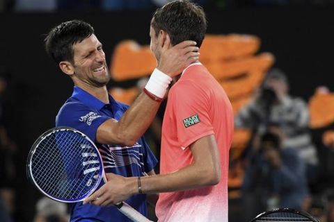 Serbia's Novak Djokovic is congratulated by Russia's Daniil Medvedev, right, after winning their fourth round match at the Australian Open tennis championships in Melbourne, Australia, Tuesday, Jan. 22, 2019. (AP Photo/Andy Brownbill)