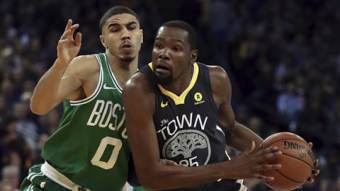 Golden State Warriors' Kevin Durant, right, drives the ball against Boston Celtics' Jayson Tatum (0) during the first half of an NBA basketball game Saturday, Jan. 27, 2018, in Oakland, Calif. (AP Photo/Ben Margot)