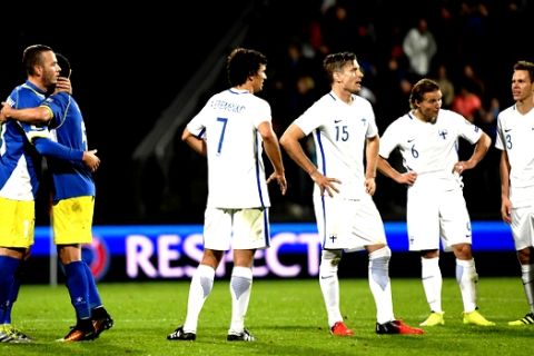 Amir Rrahmani and Enis Alushi of Kosovo, left,  jubilate while Roman Eremenko, Markus Halsti, Aleksander Ring and Niklas Moisander, right, of Finland look disappointed during the 2018 World Cup Group I qualifying soccer match in Turku, Finland, Monday Sept. 5, 2016. (Jussi Nukari/Lehtikuva via AP)