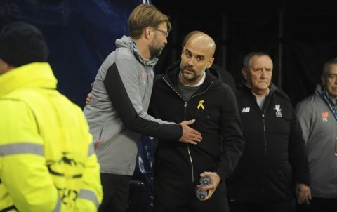 Liverpool manager Juergen Klopp, left, speaks with Manchester City manager Pep Guardiola before the Champions League quarterfinal second leg soccer match between Manchester City and Liverpool at Etihad stadium in Manchester, England, Tuesday, April 10, 2018. (AP Photo/Rui Vieira)