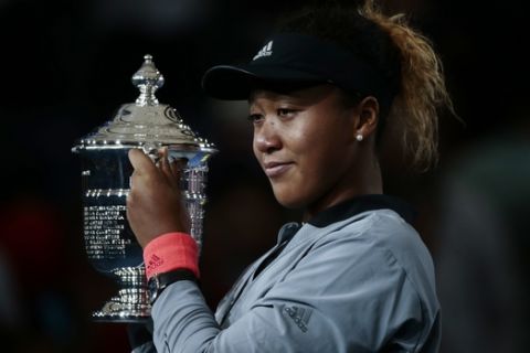 Naomi Osaka, of Japan, holds the trophy after defeating Serena Williams in the women's final of the U.S. Open tennis tournament, Saturday, Sept. 8, 2018, in New York. (AP Photo/Andres Kudacki)