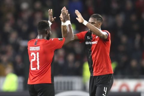 Rennes' Joris Gnagnon, left, and Rennes' Gerzino Nyamsi celebrate at the end of the the Europa League Group E soccer match between Rennes and Lazio, at the Roazhon Park stadium in Rennes, France, Thursday, Dec. 12, 2019. Rennes won 2-0. (AP Photo/David Vincent)