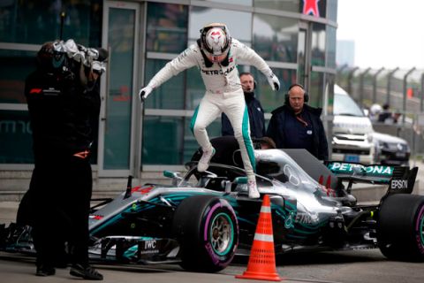 Mercedes driver Lewis Hamilton of Britain jumps off from his car after finishing fourth in the qualifying session for the Chinese Formula One Grand Prix at the Shanghai International Circuit in Shanghai, Saturday, April 14, 2018. (AP Photo/Andy Wong)