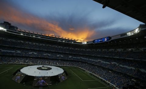Giant screens display Real Madrid's Cristiano Ronaldo pictures as supporters wait for the team to celebrate after winning the Champions League final at the Santiago Bernabeu stadium in Madrid, Spain, Sunday June 4, 2017. Real Madrid became the first team in the Champions League era to win back-to-back titles with their 4-1 victory over Juventus in Cardiff, Wales, on Saturday. (AP Photo/Francisco Seco)