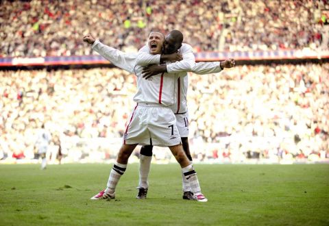 England's David Beckham celebrates the 2nd goal with Emile Heskey.